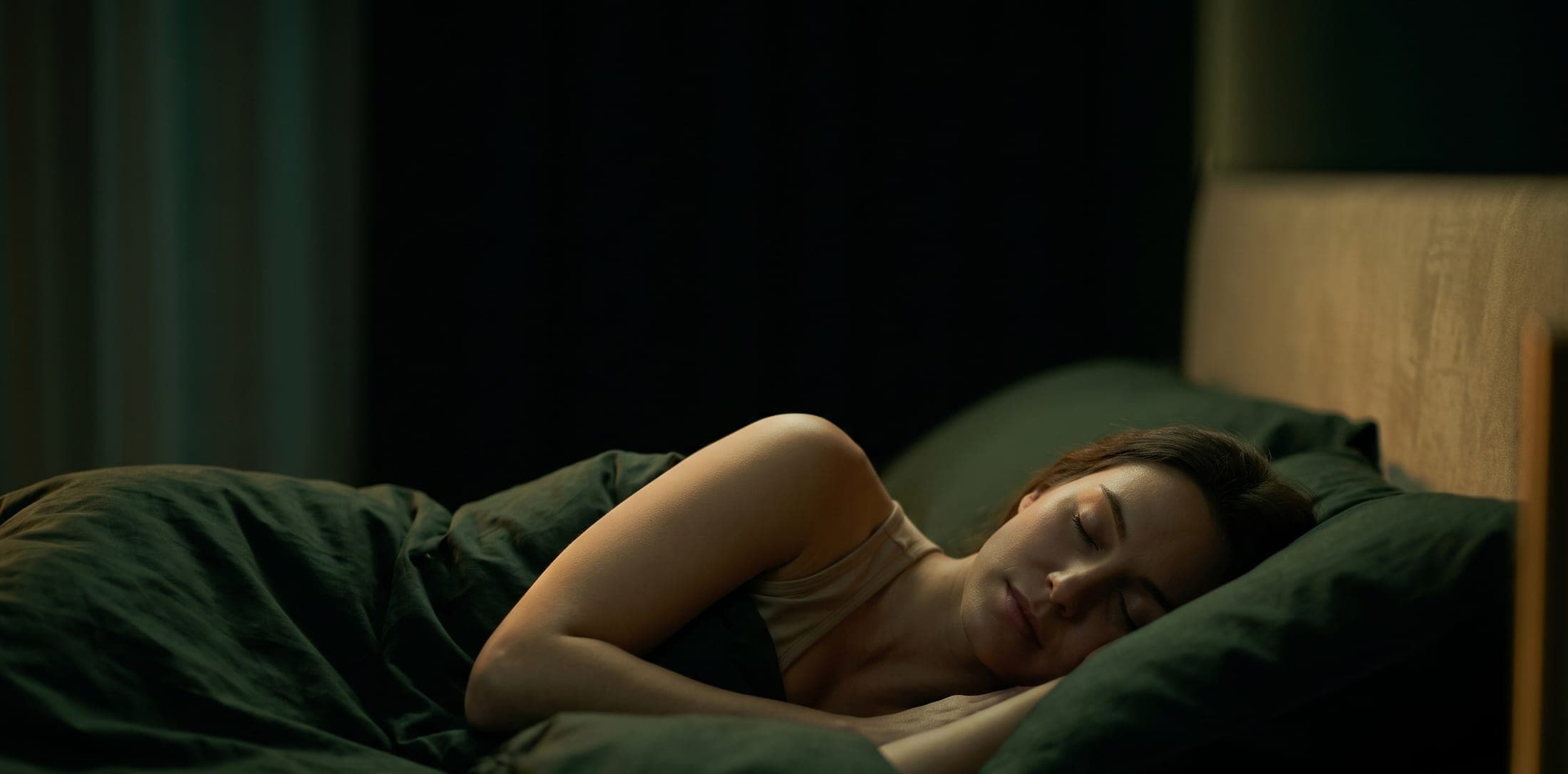 A person resting peacefully in a calm, dimly lit bedroom